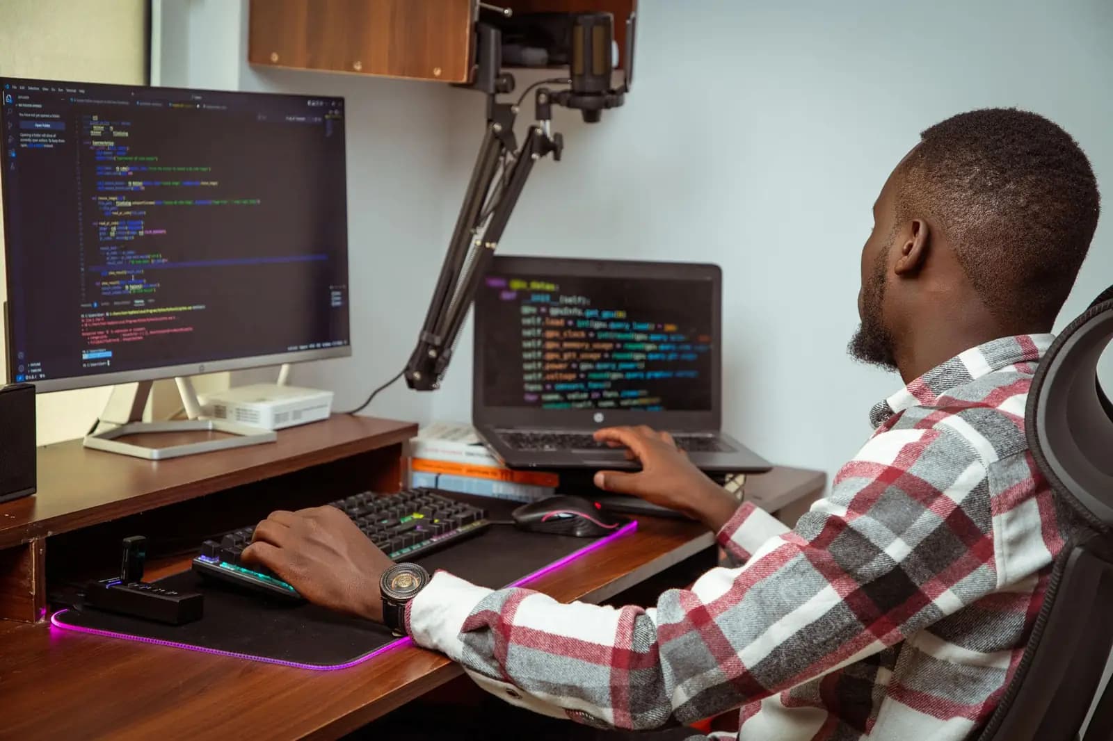 Engineer working across multiple monitors
