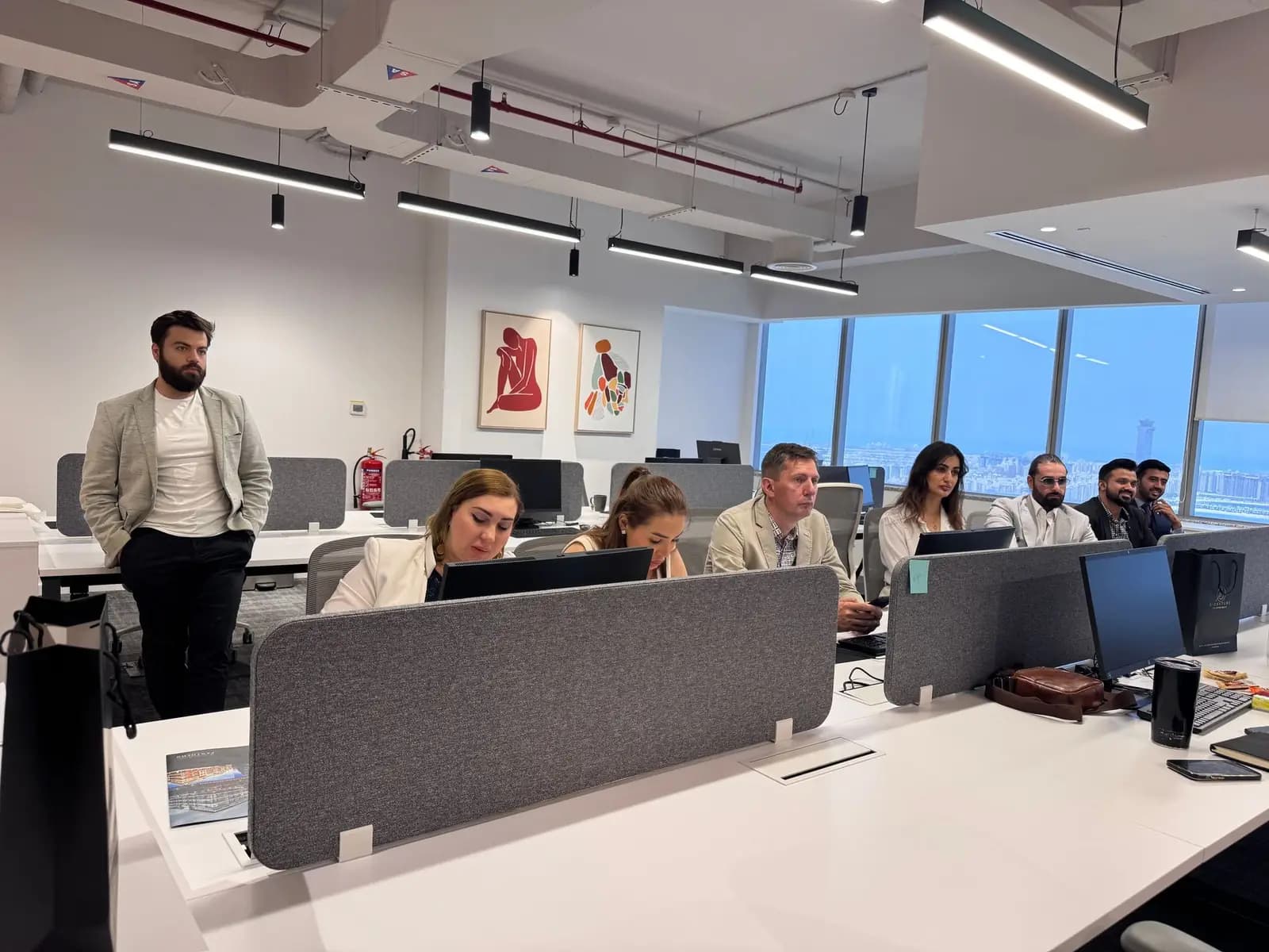 Team working on a busy open-plan office floor